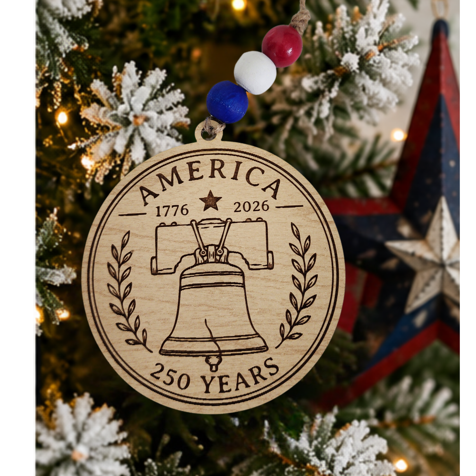 Handcrafted wooden America 250 ornament featuring Liberty Bell. Laser engraved patriotic keepsake with red, white, and blue bead accents celebrating America's 250th anniversary.