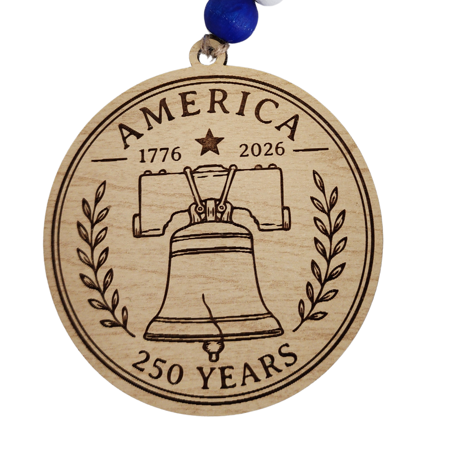 Handcrafted wooden America 250 ornament featuring Liberty Bell. Laser engraved patriotic keepsake with red, white, and blue bead accents celebrating America's 250th anniversary.