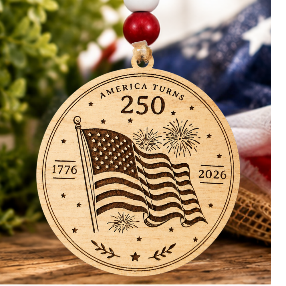 Handcrafted wooden America 250 ornament featuring Flag. Laser engraved patriotic keepsake with red, white, and blue bead accents celebrating America's 250th anniversary.