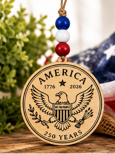 Handcrafted wooden America 250 ornament featuring Eagle. Laser engraved patriotic keepsake with red, white, and blue bead accents celebrating America's 250th anniversary.